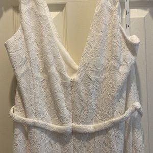 Never worn. This DB Studio white lace jumpsuit is in perfect condition.